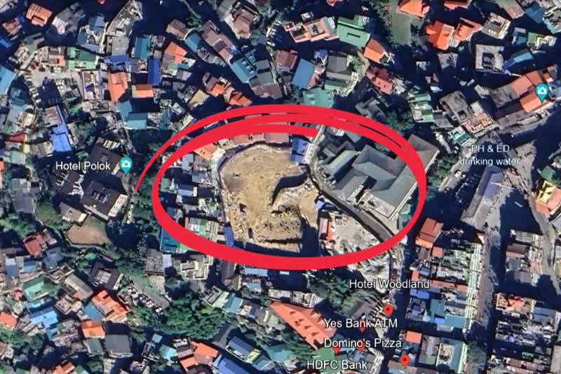 Aerial view of Gangtok's old three-story taxi stand near the old West Point School Complex post-demolition for the construction of a Multilevel Car Parking cum Shopping Hub.