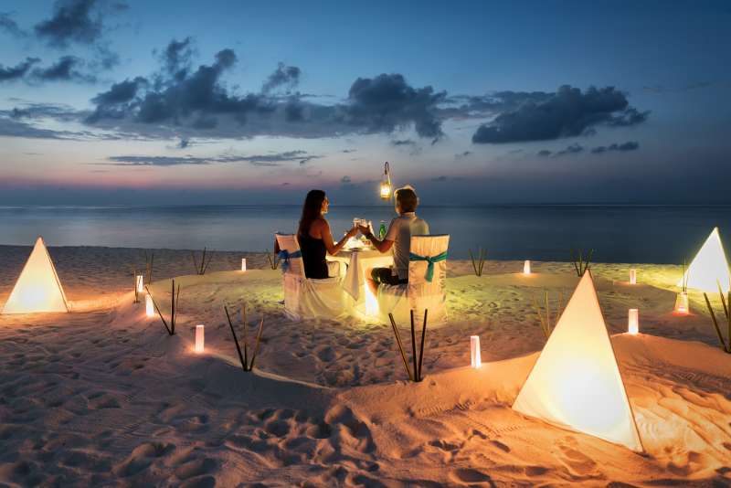 Romantic candlelit dinner for a couple on a Maldivian beach